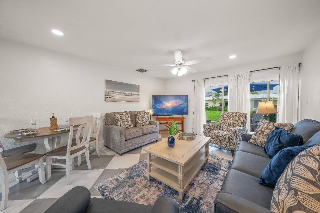 a living room with a couch and a table at Jamaica Royale Beach Villa in Siesta Key