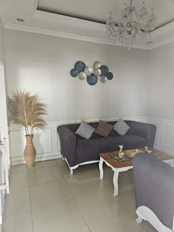 a living room with a couch and a table at Witte Huis Cirendeu in Cipayung Tiga