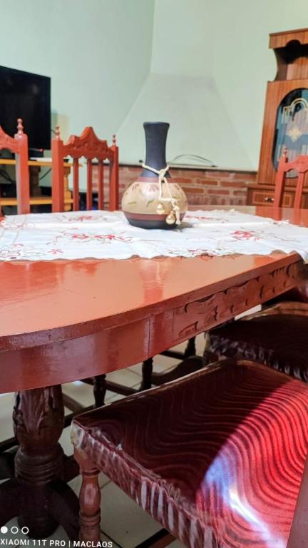 a wooden table with a vase sitting on top of it at La Cordillera in Tupungato