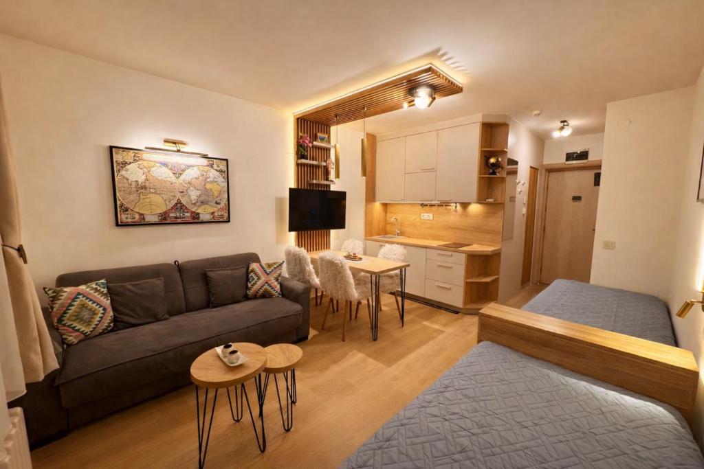 a living room with a couch and a table at Konaci Prime Center in Kopaonik