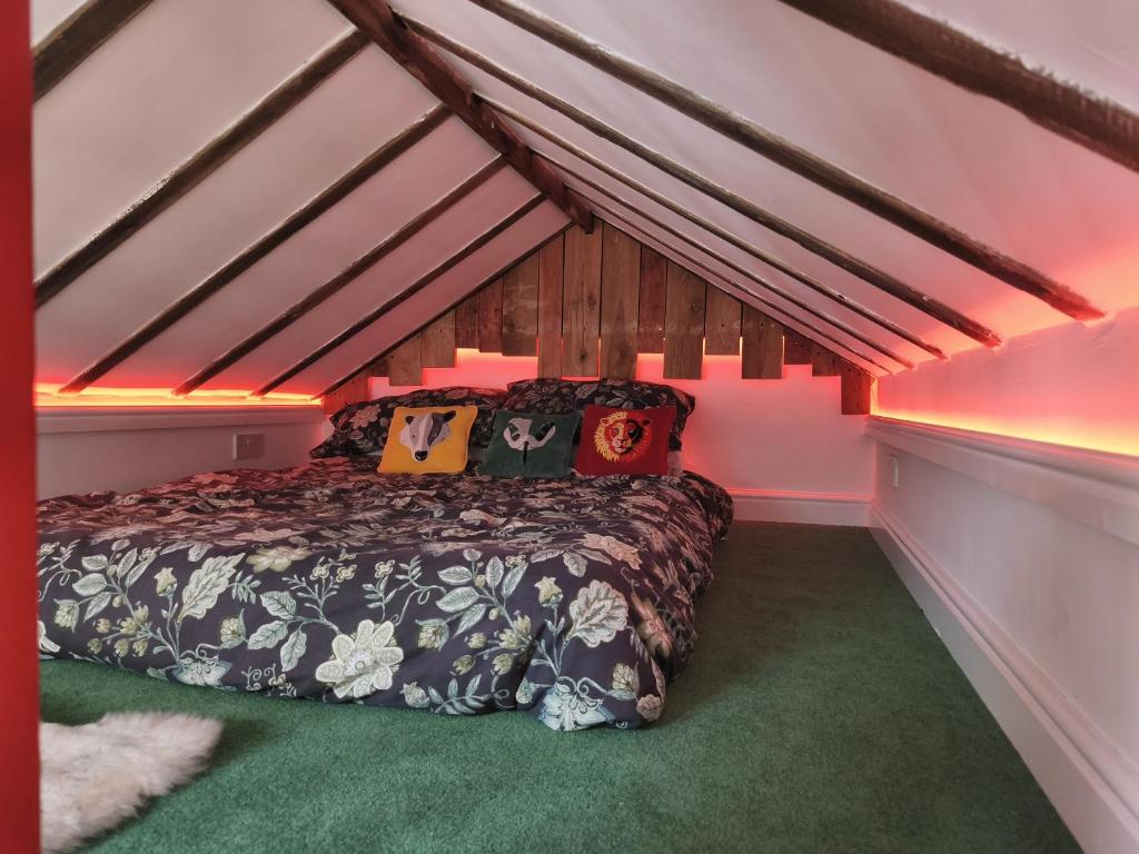 a bedroom with a bed in a attic at Zanders cave in Edwinstowe