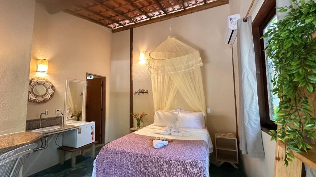 Giường trong phòng chung tại Casa Bio Arraial DAjuda