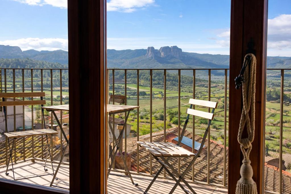 a balcony with chairs and a view of the mountains at Ca l'Era in Horta de San Joan