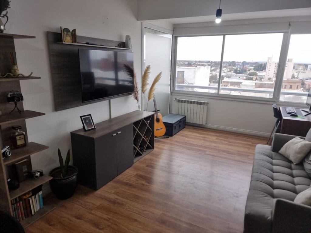 a living room with a couch and a television at Premium apartment San Luis Centro in San Luis
