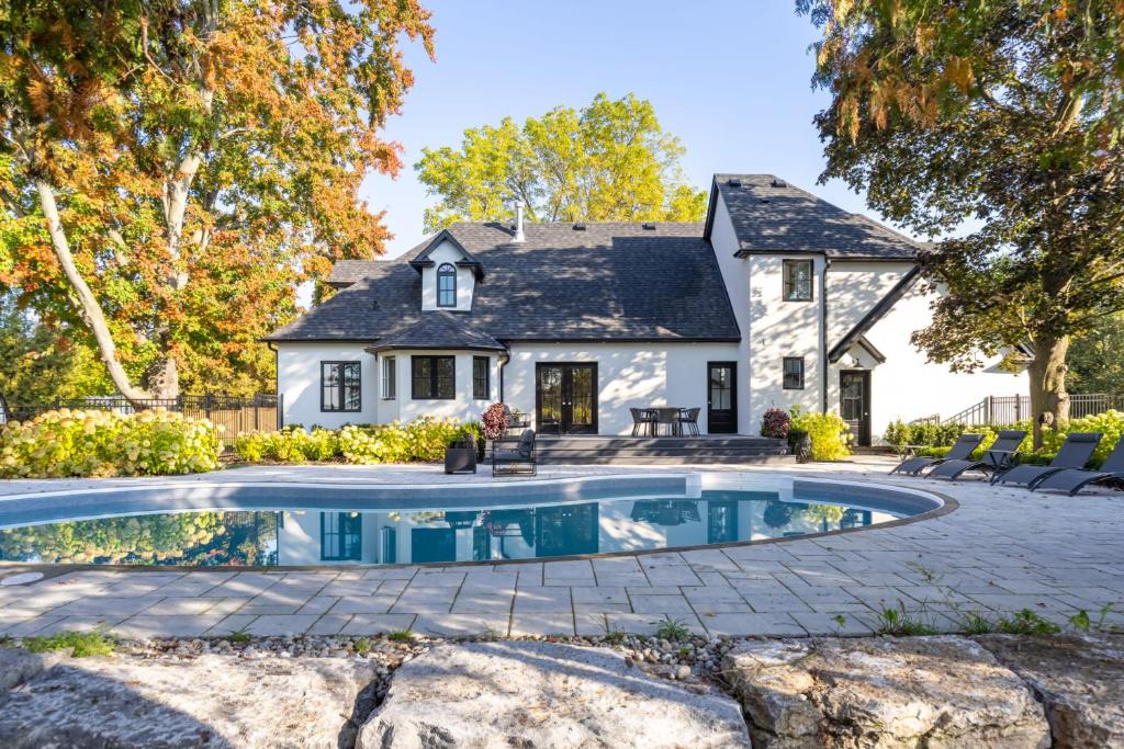 an exterior view of a house with a swimming pool at Vineyard Estate by the River with Pool in Niagara-on-the-Lake