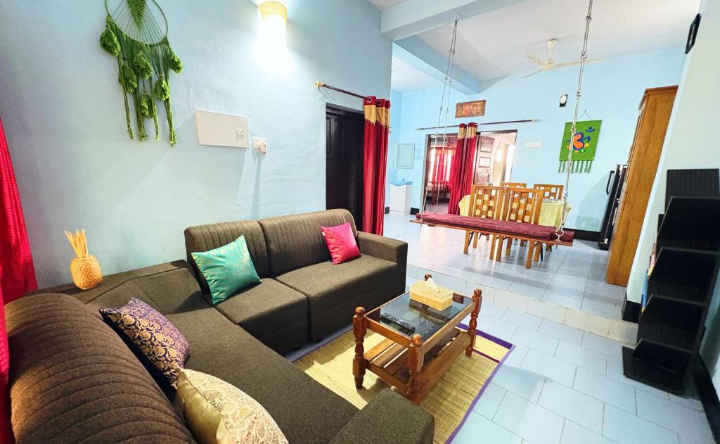 a living room with a couch and a table at Saralalayam in Varkala