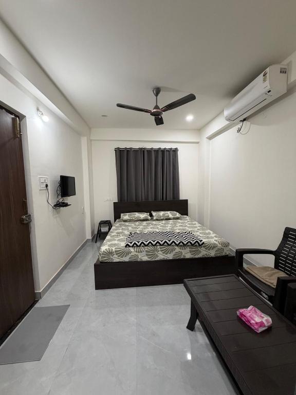 a bedroom with a bed and a ceiling fan at RS Rooftop in Hyderabad