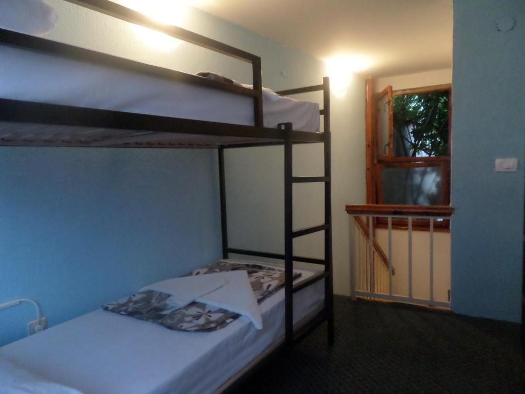 Cette chambre comprend 2 lits superposés et une porte. dans l'établissement Guesthouse Titi Mostar, à Mostar