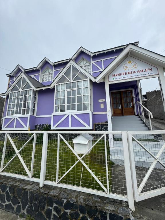 a purple house with a fence in front of it at Hosteria Ailen in Ushuaia