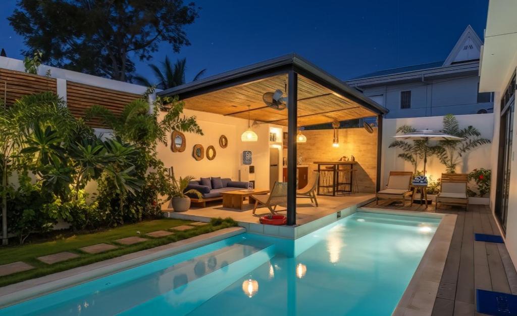 a pool in a backyard with a gazebo at Villa Kasadya in Panglao