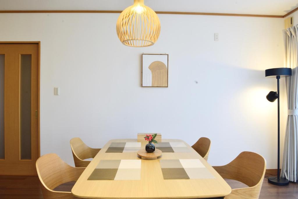 a dining room with a table and chairs at 結-musubi- in Miyazaki