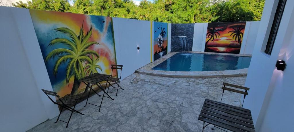 a patio with chairs and a swimming pool at Hostal y Piscina in La Romana