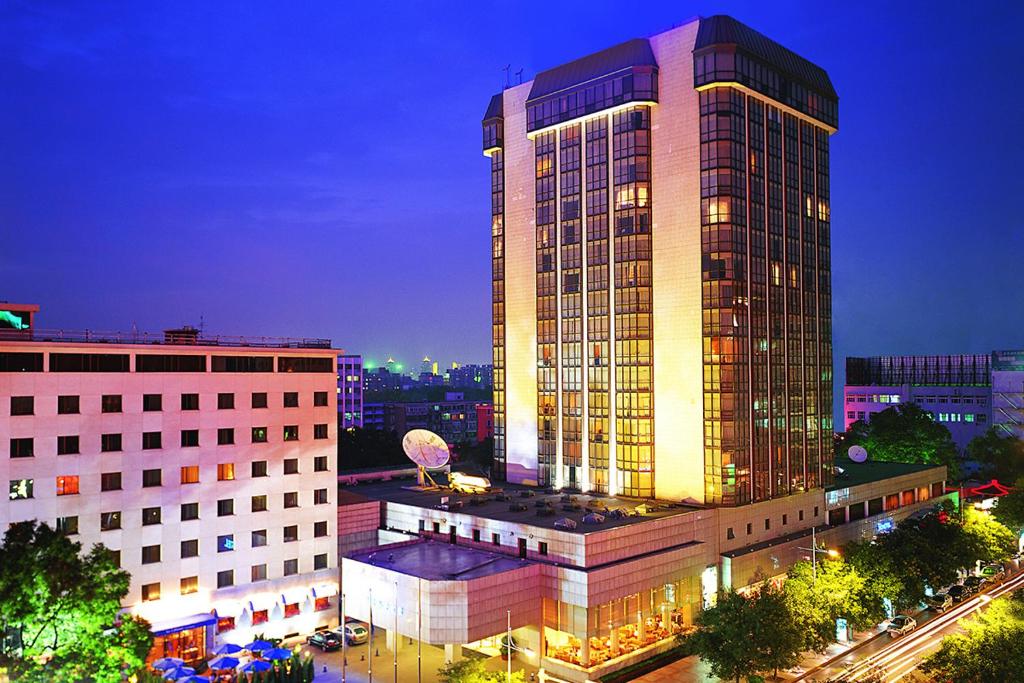 een hoog gebouw met veel licht erop bij Peace Hotel Beijing in Beijing
