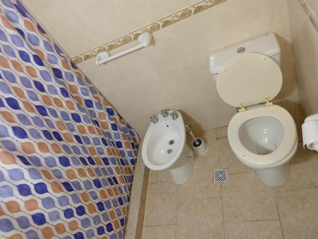a bathroom with a toilet and a bidet at Casa ruau in Valeria del Mar