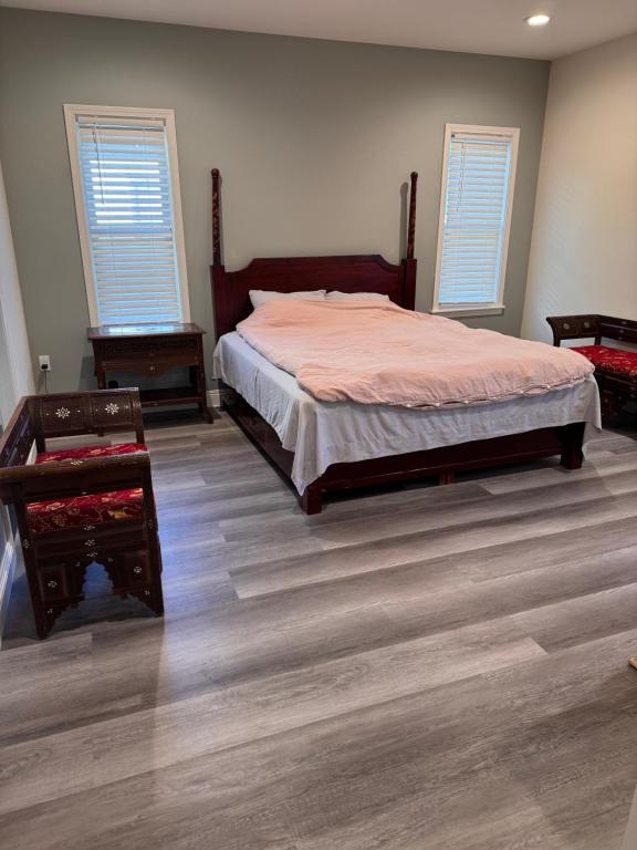 ein Schlafzimmer mit einem Bett und einem Holzboden in der Unterkunft Modern 3BR Condo with 2-Car Garage in Pasadena