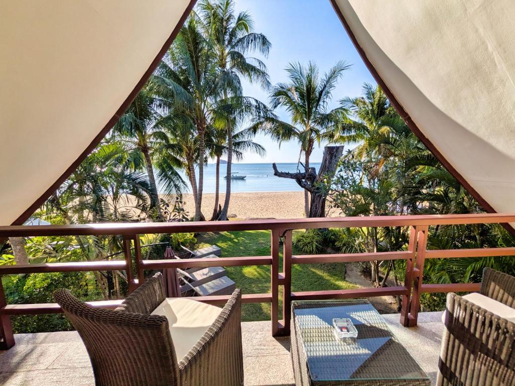 a view of the beach from the balcony of a resort at Five Palms Beachfront Villa - by KohChangVillas in Ko Chang