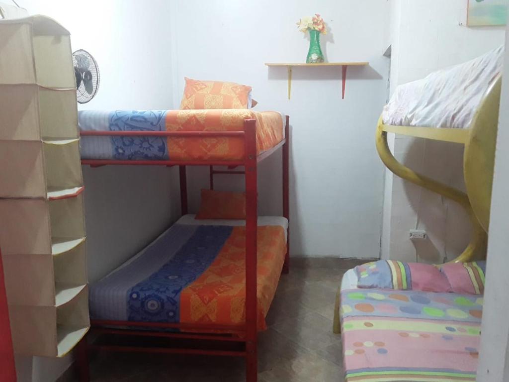 a room with two bunk beds and a table at Caribe Tolú in Tolú