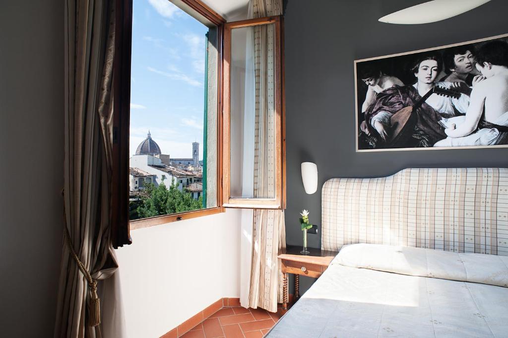 Łóżko lub łóżka w pokoju w obiekcie Hotel Caravaggio
