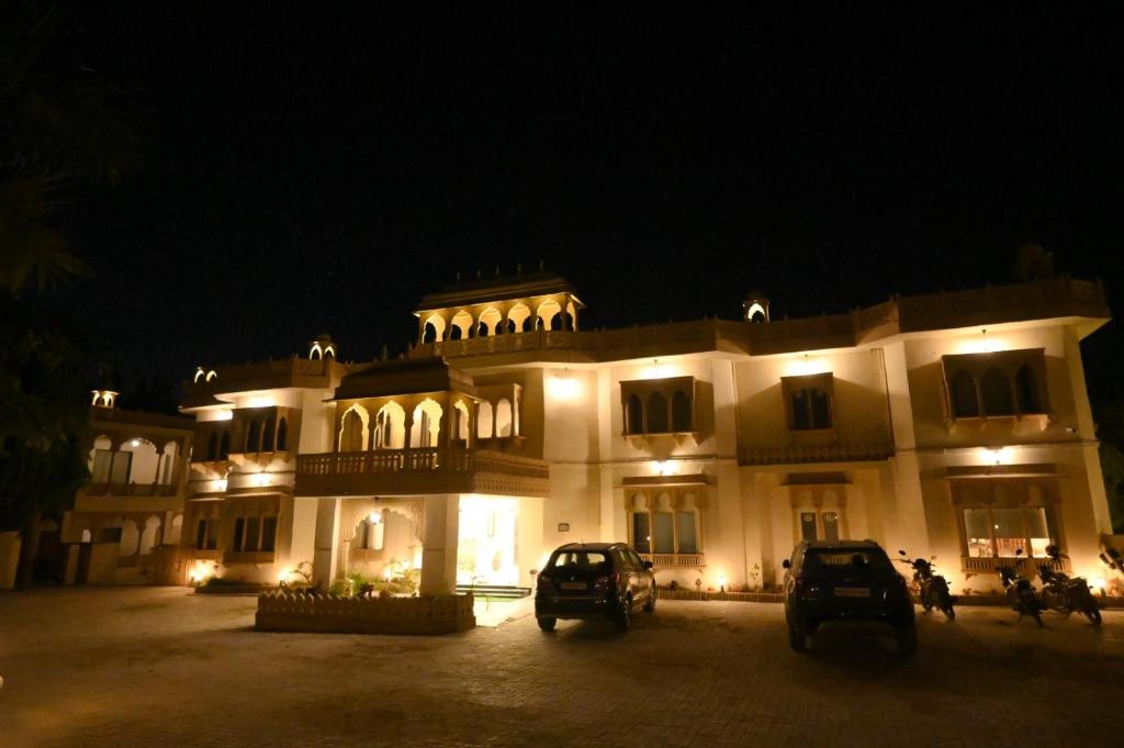 a large building with cars parked in front of it at night at The Van Bagh Ranthambore in Sawāi Mādhopur