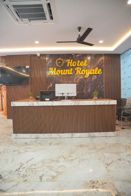 a hotel lobby with a hotel mount royale sign on the wall at Hotel Mount Royale in Hyderabad