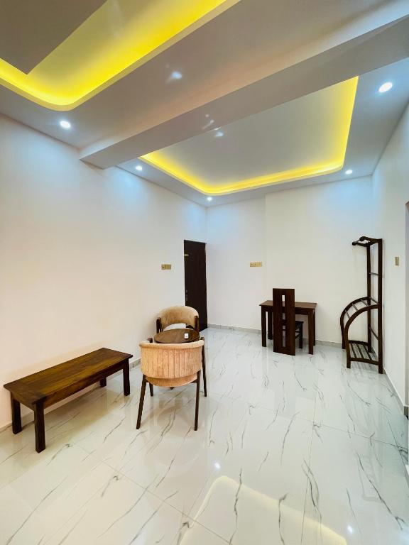 a living room with a table and a couch and a table at Sky View in Matara