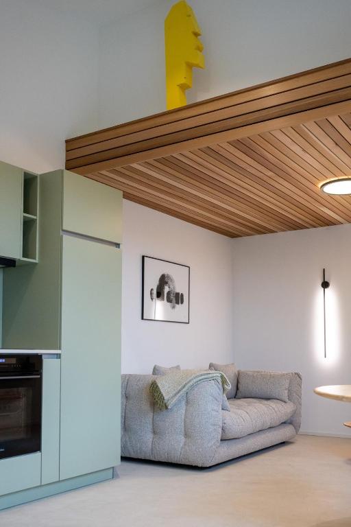 a living room with a couch and a wooden ceiling at Le Marzelheide 3 in Lontzen