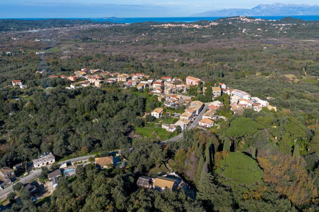 an aerial view of a town in the middle of a forest at Casa Sorgente in Ágioi Doúloi