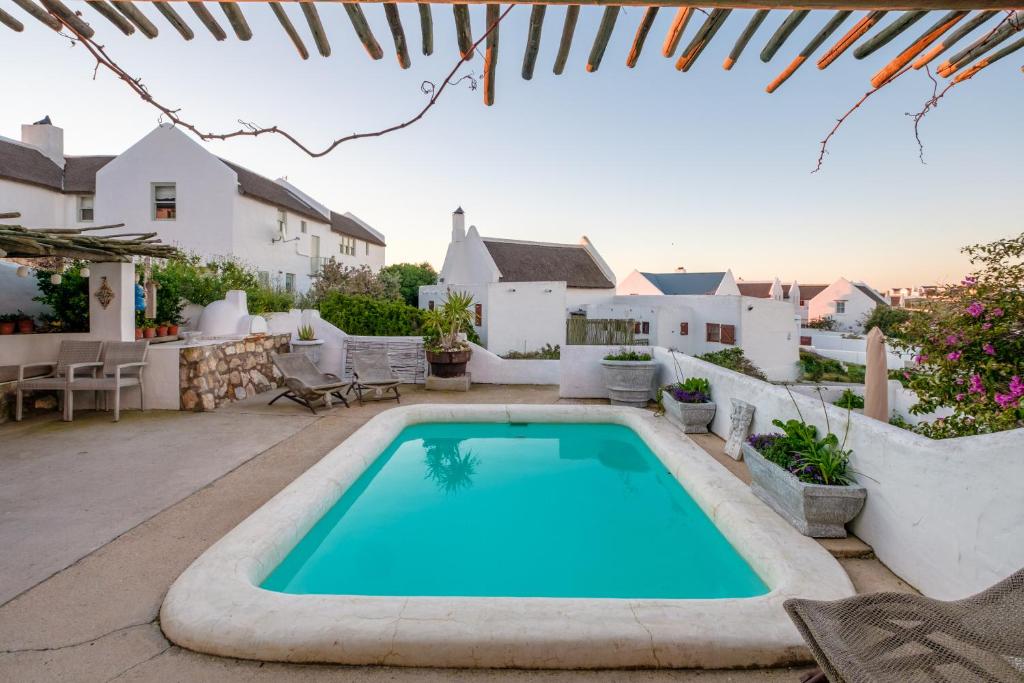 a swimming pool in the backyard of a house at Smugglers' BnB in Paternoster