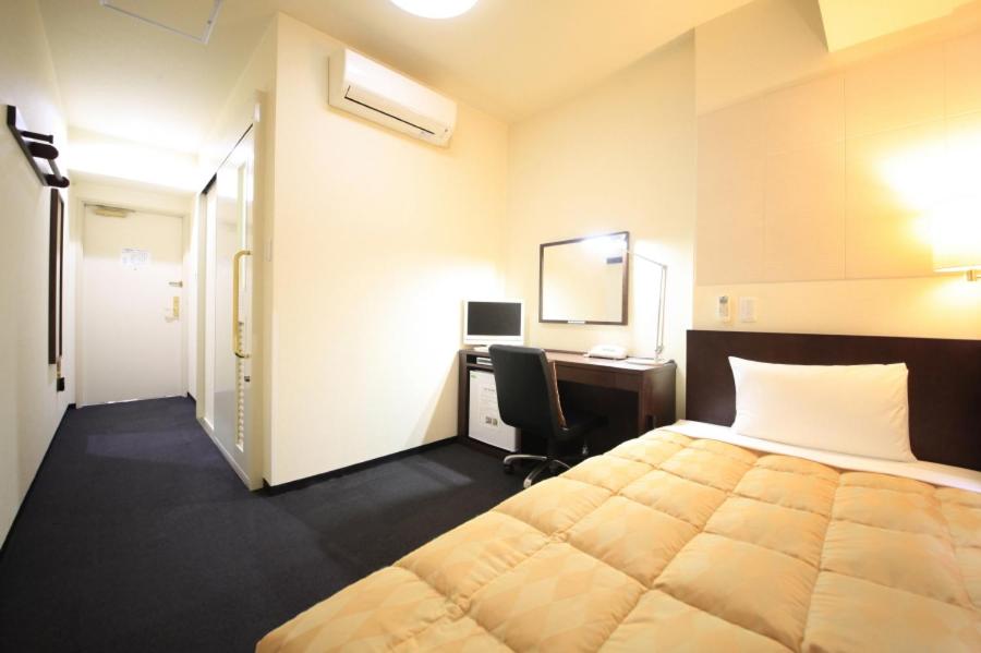 Postel nebo postele na pokoji v ubytování Fuchu Urban Hotel Annex