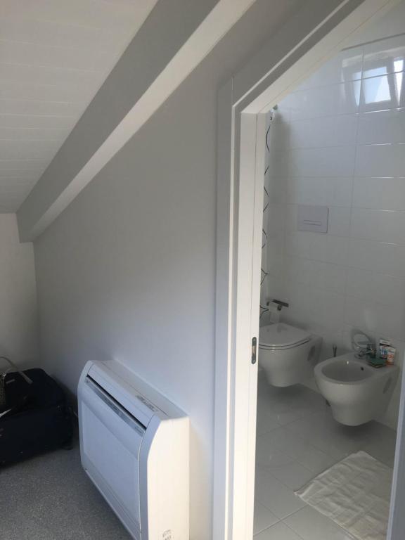 a white bathroom with a sink and a toilet at Casa Maria in Salerno