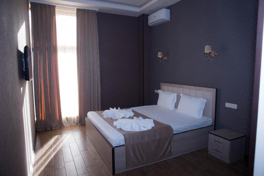 Postel nebo postele na pokoji v ubytování Eridana Hotel