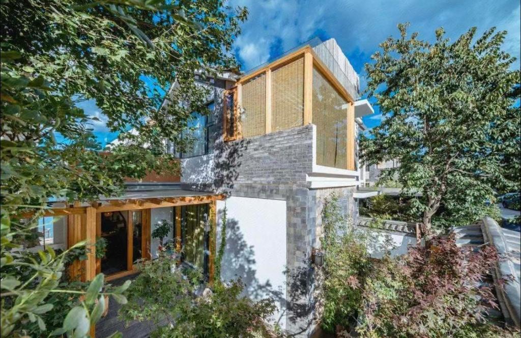 a house with a stone facade and wooden at Nanshe Nan Inn Dali in Dali Airport