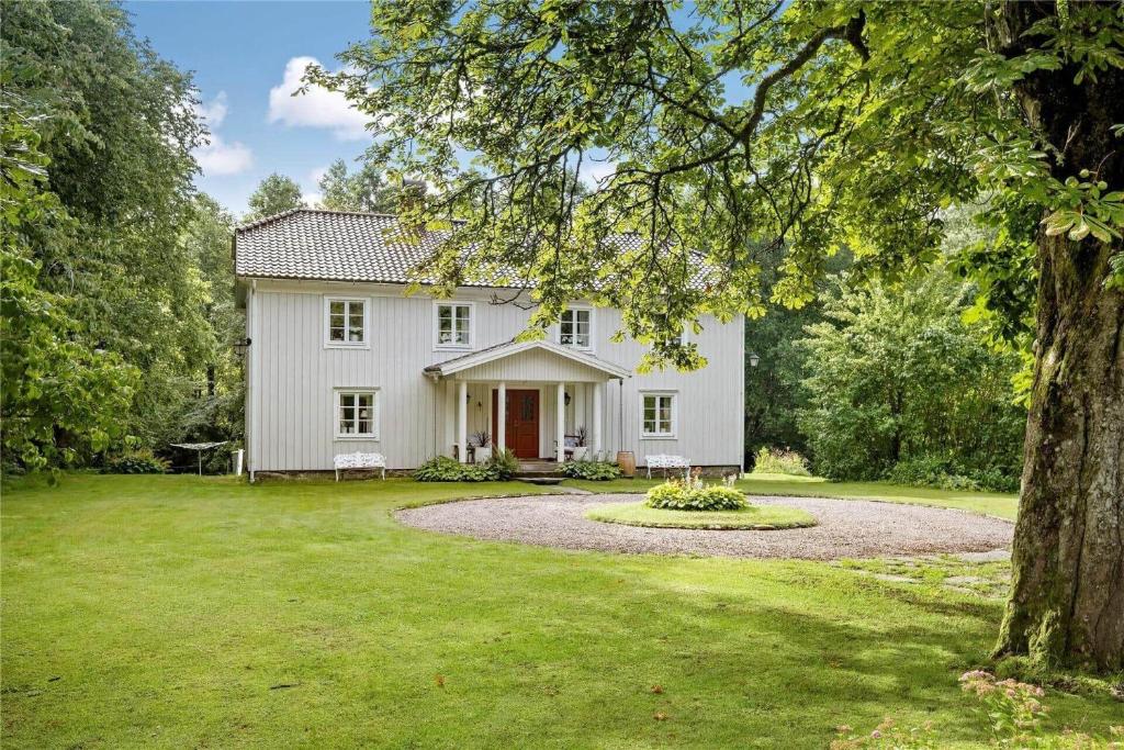a large white house with a large yard at HAL484-Unnaryd-Yas-108 in Unnaryd