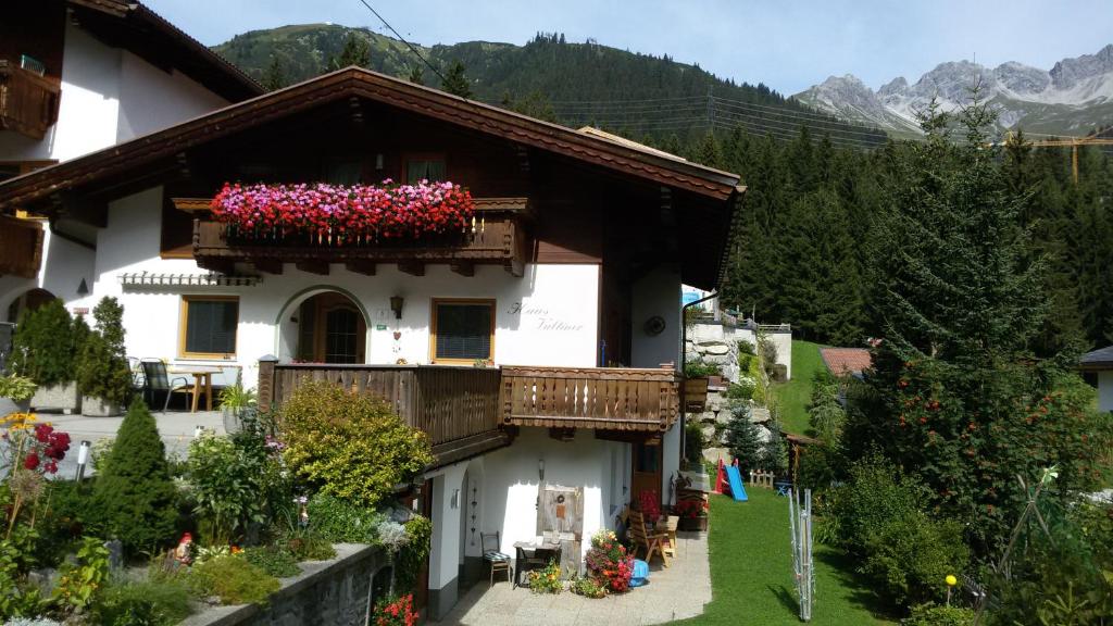 a house with a balcony with flowers on it at Apartment Valtiner in Sankt Anton am Arlberg