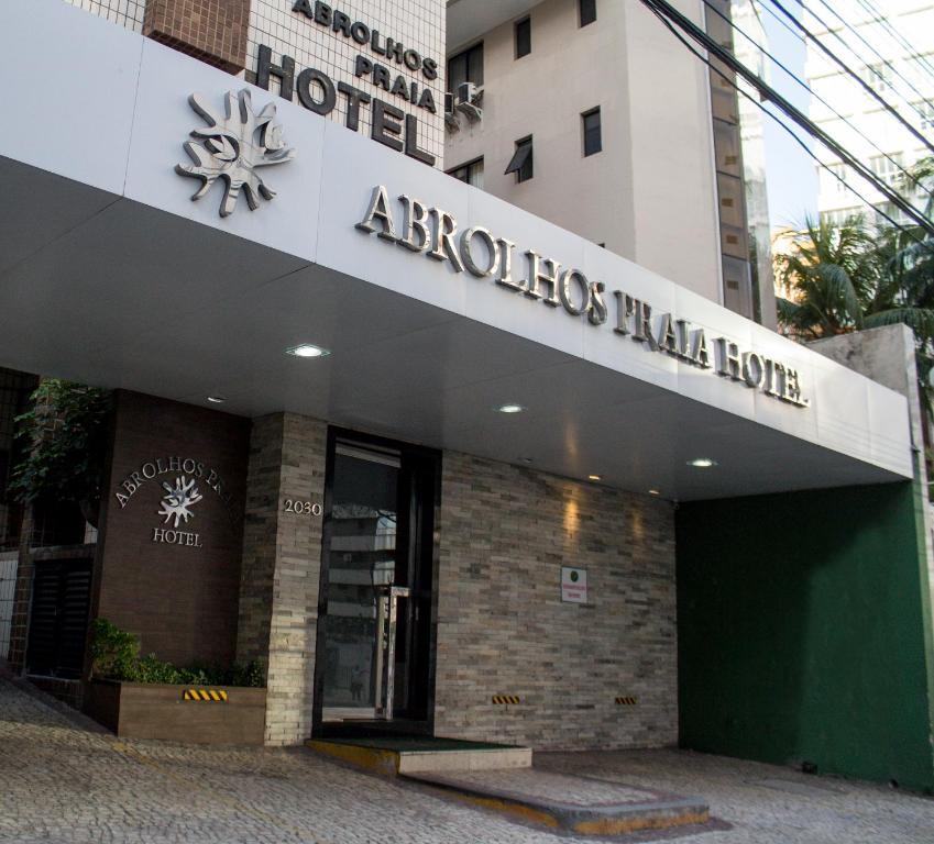 a building with a sign on the front of it at Abrolhos Praia Hotel in Fortaleza