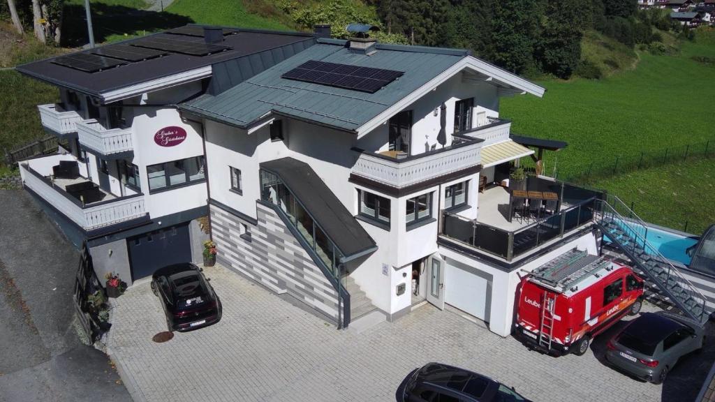 a house with a fire truck parked in front of it at Gruber's Gästehaus in Viehhofen