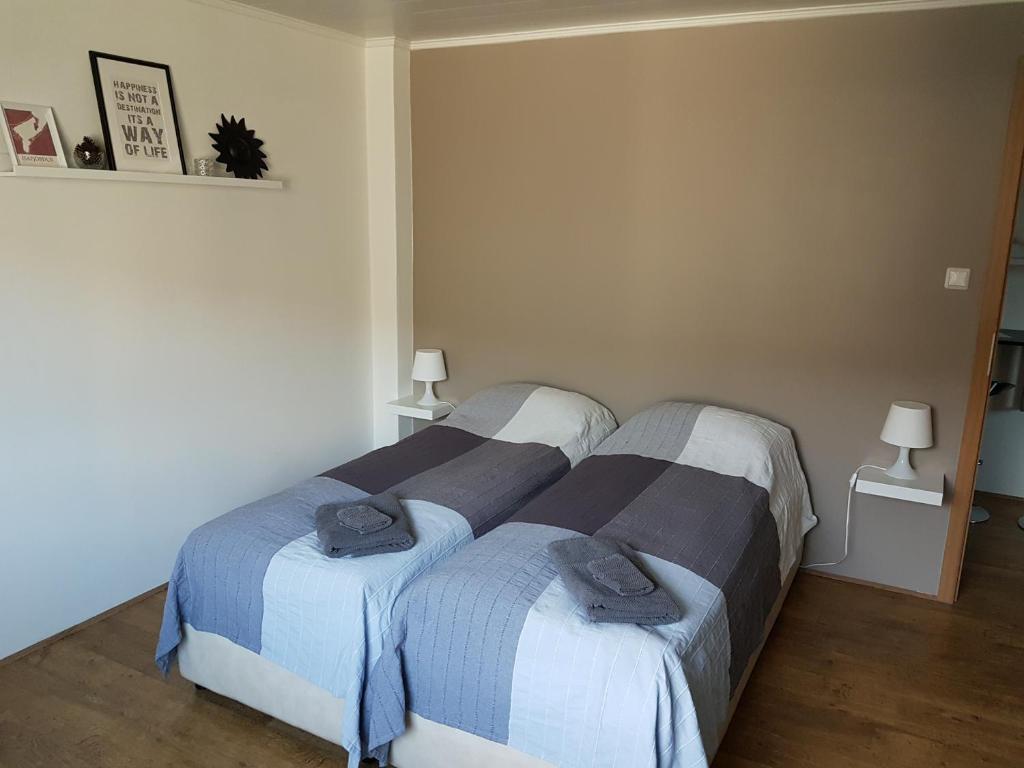 a bedroom with two beds with towels on them at Sigurhæð - Apartment with all within your reach in Ísafjörður