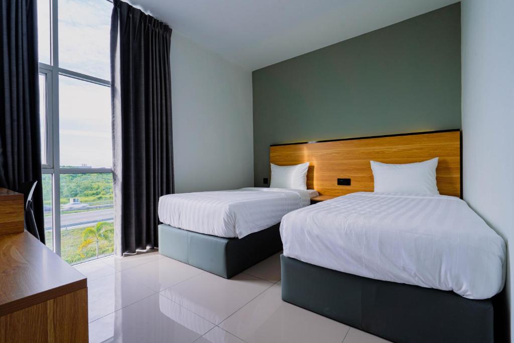 Giường trong phòng chung tại Hotel M9 Sepang KLIA & KLIA 2