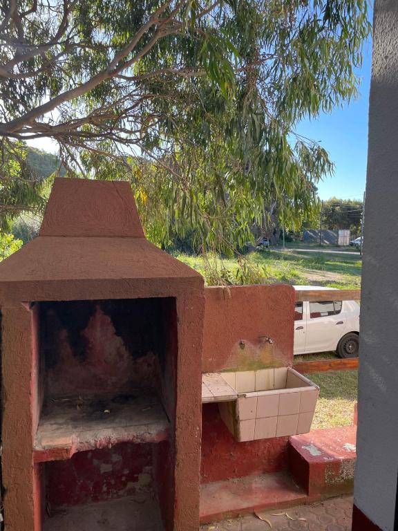a brick oven sitting next to some boxes at Teresita6 in Santa Teresita