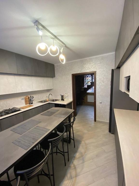 a kitchen with a table and some chairs in it at ViLLA KUMANETS in Skhidnitsa