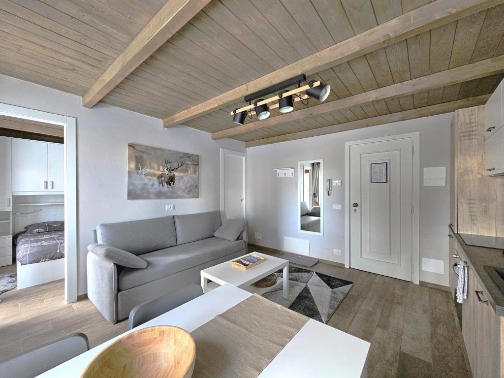 a living room with a couch and a table at Moda Apartments G1 in Sestriere