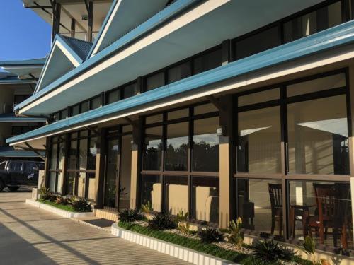 a building with large windows on the side of it at Nambis Inn in Madang