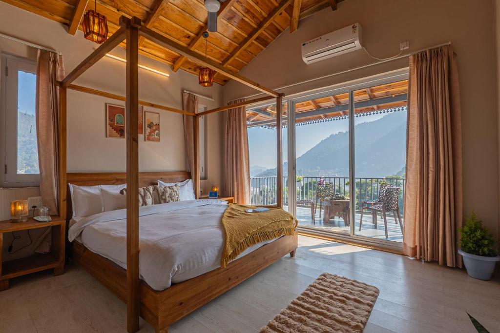 a bedroom with a canopy bed and a balcony at SaffronStays The Kumaoni Abode in Bhīm Tāl