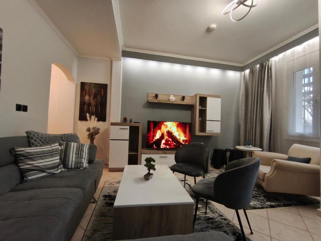 a living room with a couch and a fireplace at Xryspa suites in Ioannina