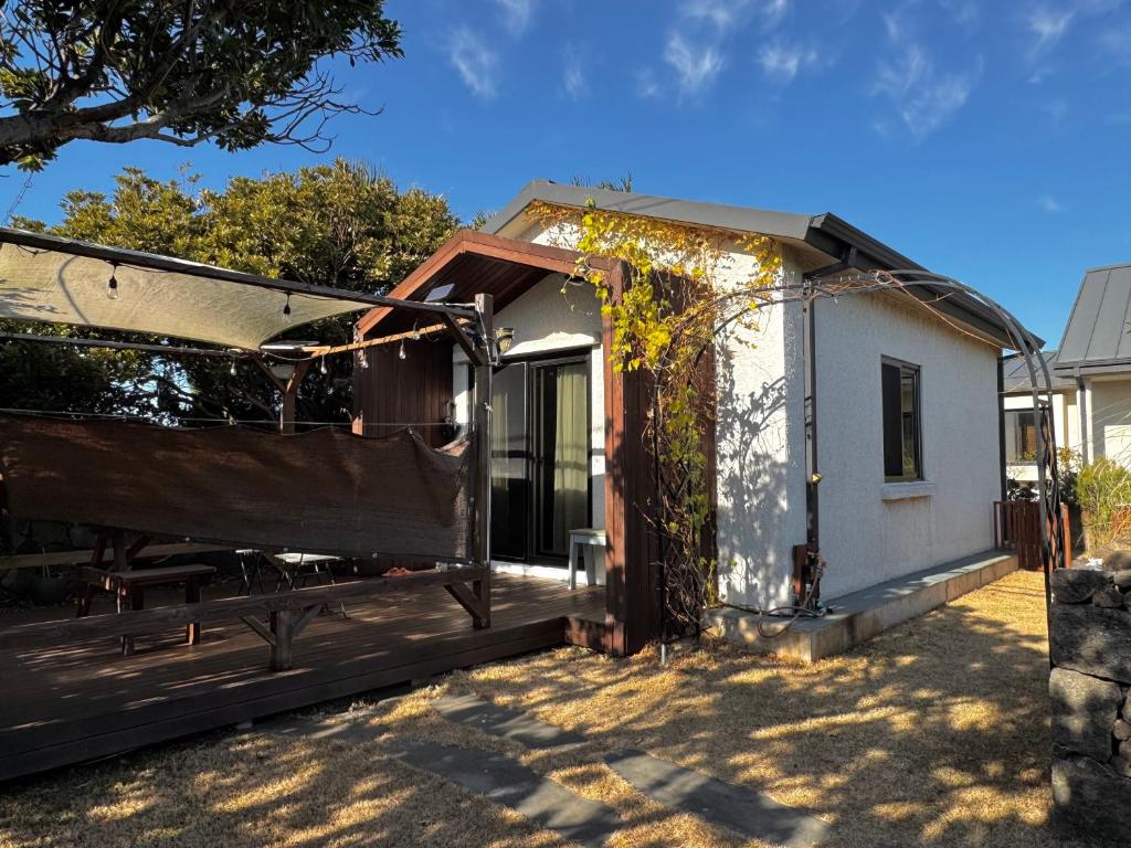 a house that is sitting in the yard at Miru House in Seogwipo