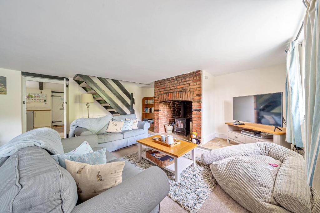 a living room with a couch and a fireplace at Mill View in Harpley