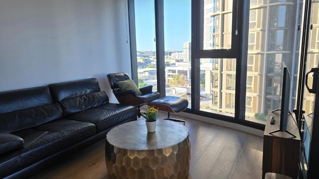 a living room with a couch and a coffee table at FV 1BR APT with Rooftop Pool in Brisbane