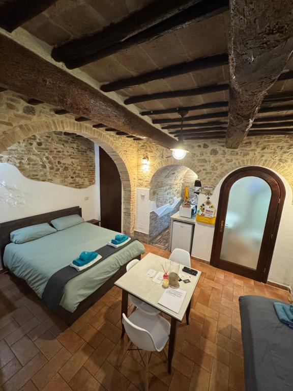 a bedroom with a bed and a table in a room at Casa Leon - City center in Perugia
