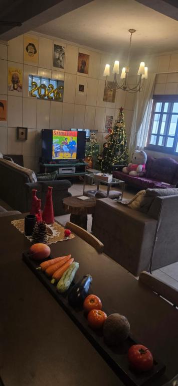 a living room with a christmas tree in a living room at Hostel Barato Zona Sul in Porto Alegre