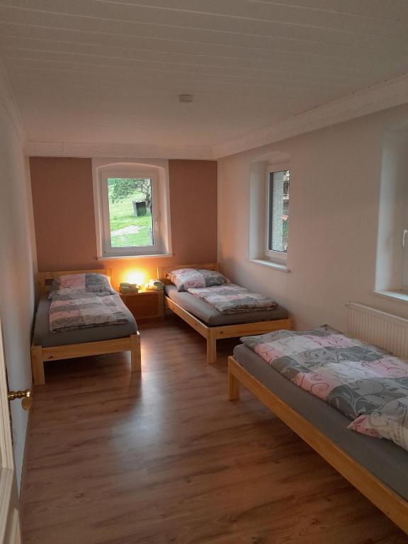 a room with three beds and two windows at Ferienhaus Koenig in Kulmain